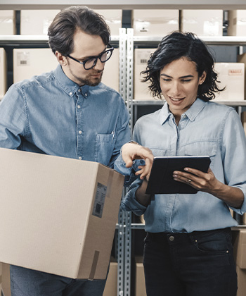 man and woman looking at tablet